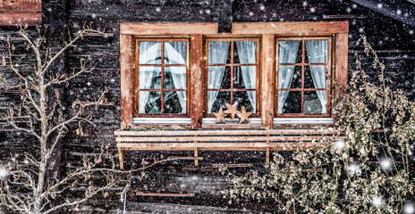Fototapeta na wymiar traditional Swiss wooden hut and snowfall