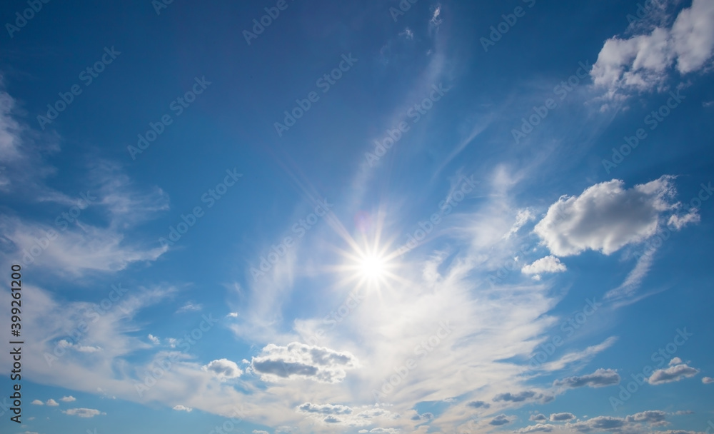 Wall mural blue sky with clouds and bright sun