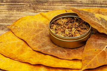 Shredded tobacco in a tin box and high quality cured big leaves to make cigars