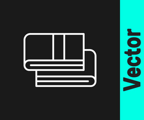 White line Towel stack icon isolated on black background. Vector.