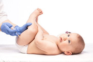 Doctor injecting a vaccine in leg of baby girl