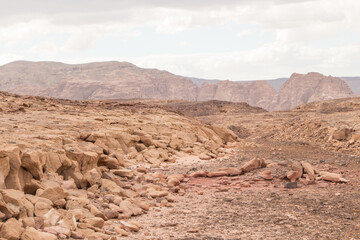 Desert, red mountains, rocks and cloudy sky. Egypt, color canyon.