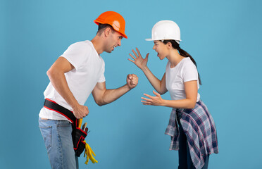 Renovation And Conflicts. Young couple in hard hats arguing during house repair