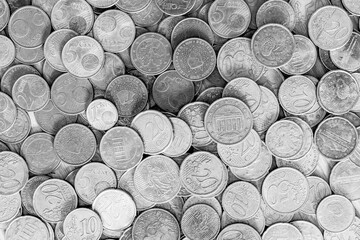Euro coins in black and white seen from above filling whole image