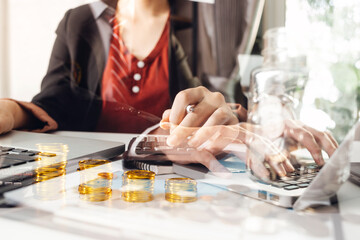 Business people use tablets and hold credit cards as an online shopping concept With a calculator and a book placed on the table