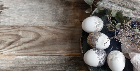 Obraz premium Easter composition with decorative eggs on a wooden surface copy space.