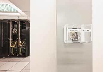 Mains power switch in computer server room with computer server cabinet.