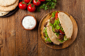 Kebab, kofta in pita, bun. Traditional southern European dish. Top view.