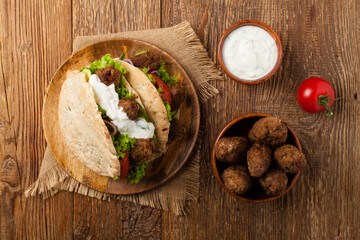 Kebab, kofta in pita, bun. Traditional southern European dish. Top view.