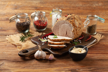 Crispy, cooked ham. Served with spices on a wooden board.