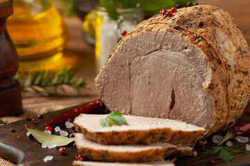 Crispy, cooked ham. Served with spices on a wooden board.