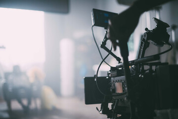 Professional film and video camera on the set. Shooting shift, equipment and group.