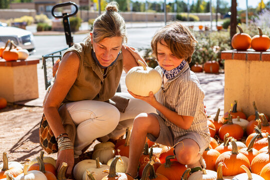 Mother and her young son in pumpkin patch.