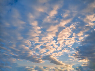 Evening blue sky with cumulus clouds. Cumulus clouds in the blue sky. Beautiful clouds in the blue sky background.