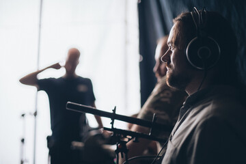 Sound engineer with a microphone on the set.