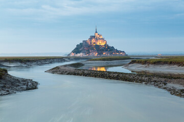 Mont St Michel at dusk on the tidal estuary
