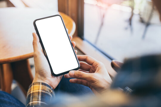 cell phone blank white screen mockup.woman hand holding texting using mobile on desk at office.background empty space for advertise.work people contact marketing business,technology