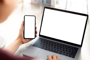 computer screen,cell phone blank mockup.hand woman work using laptop texting mobile. with white background for advertising,contact business search information on desk in cafe.marketing,design