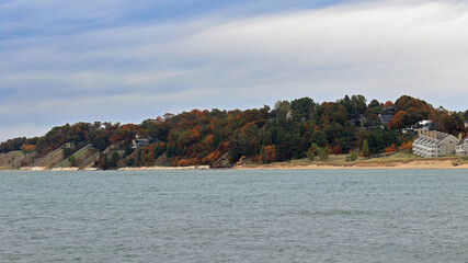 Lake shore with trees in autumn foliage