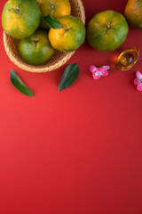 Top view of fresh tangerine mandarin orange on red background for Chinese lunar new year.