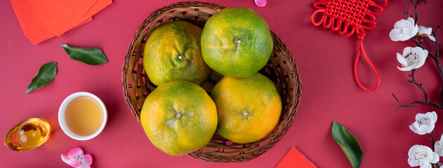 Top view of fresh tangerine mandarin orange on red background for Chinese lunar new year.