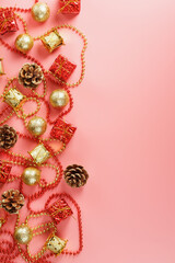 Christmas or new Year pink background with red and gold decorations for Christmas tree with free space.