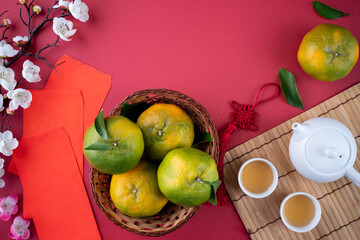 Top view of fresh tangerine mandarin orange on red background for Chinese lunar new year.