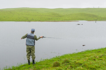 Black bass fisherman fishing