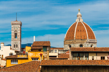 Gorgeous panoramic rooftop view of Florence with the Cattedrale di Santa Maria del Fiore. The dome with cupola and the free-standing bell tower (Giotto's Campanile) stick out from the other buildings.