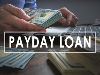 Payday loan concept. The man offers a wad of cash.