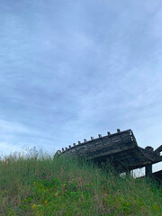 wooden boat remains over a hill