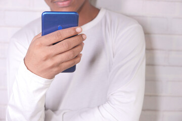  young man in casual dress using smart phone.