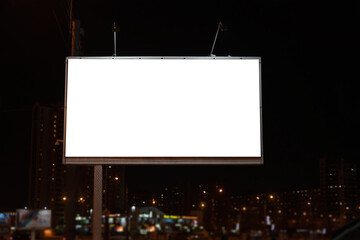 Advertising billboard at night with white field for advertising