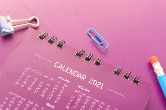 new year goals concept with 2021 calendar on color background 
