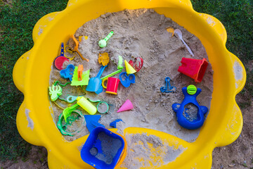 Plastic sandbox for children full of toys.