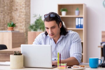 Young male businessman employee working in the office