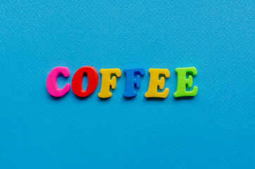 word coffee on blue paper background