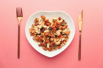  top view of many mixed nuts on heart shape plate 