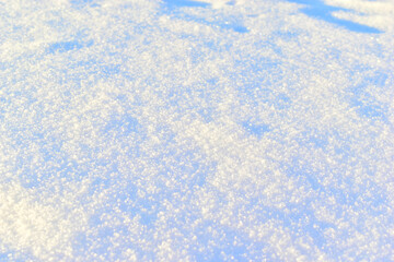 White surface of loose snow in winter with a blue tint