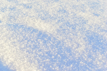 White surface of loose snow in winter with a blue tint