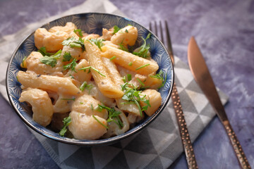  homemade cooked pasta in a plate on table .