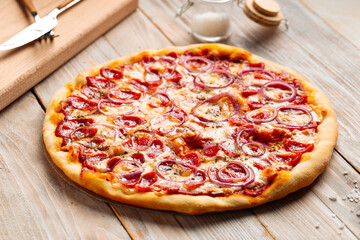Side view on hunter's sausage pizza on the wooden rustic table
