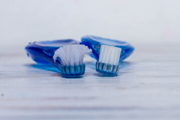 New and old toothbrushes on white background. Copy space.