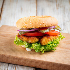Closeup on zinger burger with deep fried chicken on the wooden table