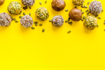 Raw energy balls with coconut and pumpkin seeds, top view