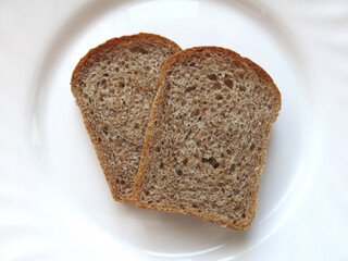 Bread on white background. Toast bread on white background. Bread piece in a white plate.   