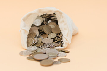 from a small bag on a beige background, Russian coins poured out. Horizontal photo. Big plan.
