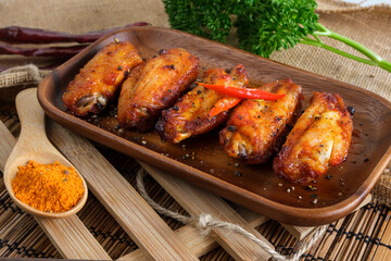 Spicy buffalo chicken wings covered by spices.