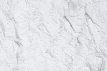 Crumpled white paper background.