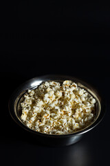 Portion of popcorn. Popcorn on black.